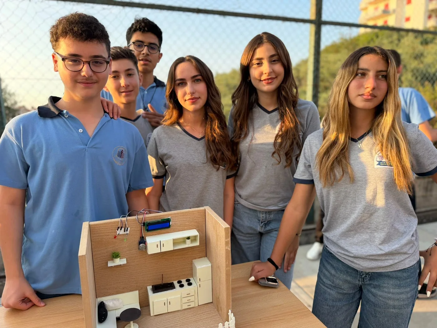 Students presenting a model smart-home technology project